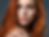 Pitta dosha symptoms: woman with pitta characteristics of red hair, sharp features, and light, penetrating eyes looking at the camera