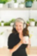 A woman wearing headphones ready to engage in a Wise Woman Ayurveda audio practice for nervous system regulation and embodied learning.