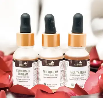 The three bottles of face, nose, and ear oil by Athreya Herbs.