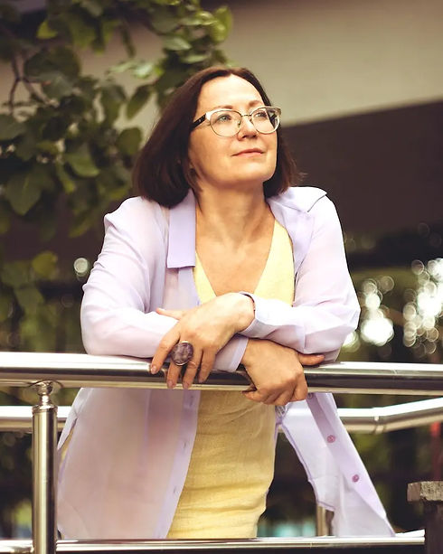 A woman in her 40s with a peaceful expression, reflecting the results of an Ayurvedic consultation.