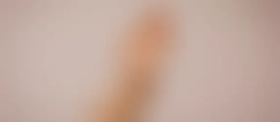 A woman giving herself an oil massage before sleep as a bedtime ritual for women 40+.