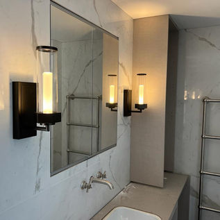 Lantern style lights either side of a bathroom mirror