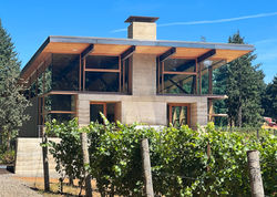 Rammed earth winery building at Rodeo Hills in Newberg, Oregon, seen from the vineyard