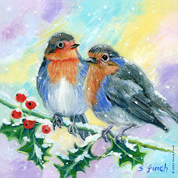 two robins perched on a holly leaf