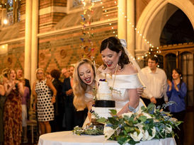 Brides cutting wedding cake
