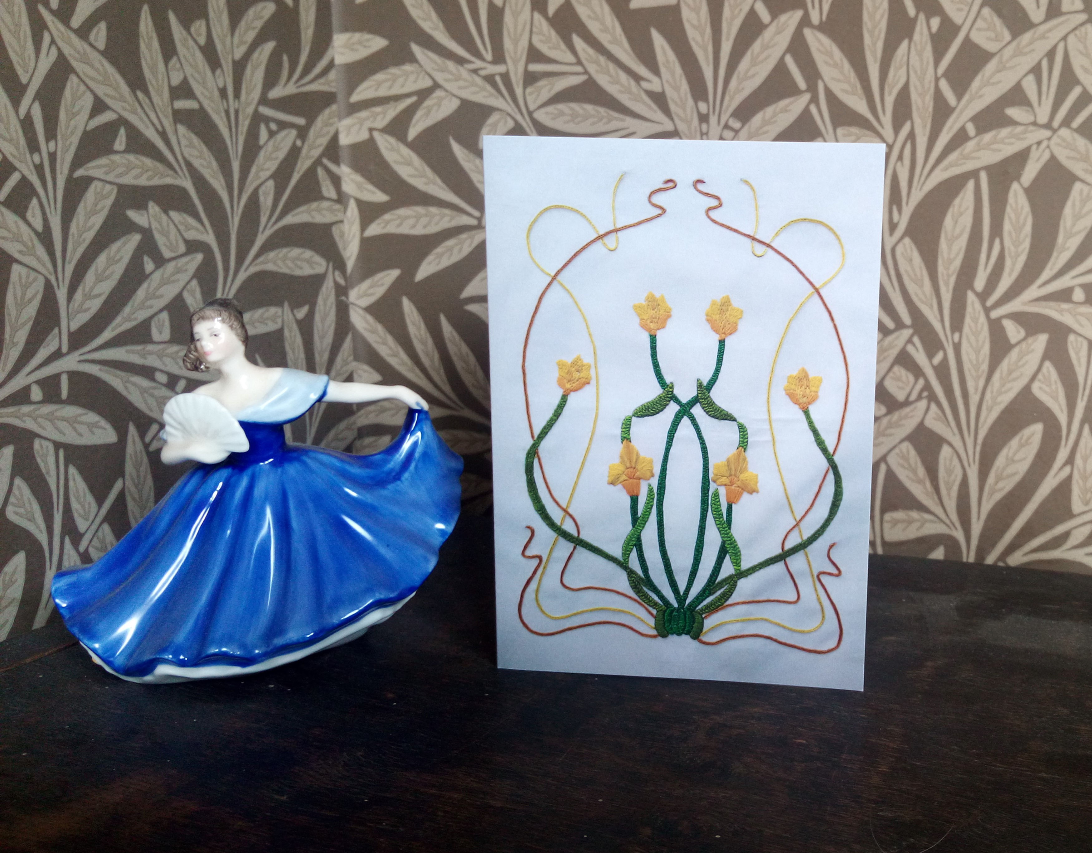 Greetings card featuring hand embroidered textile artwork inspired by Art Nouveau with yellow flowers and green stems