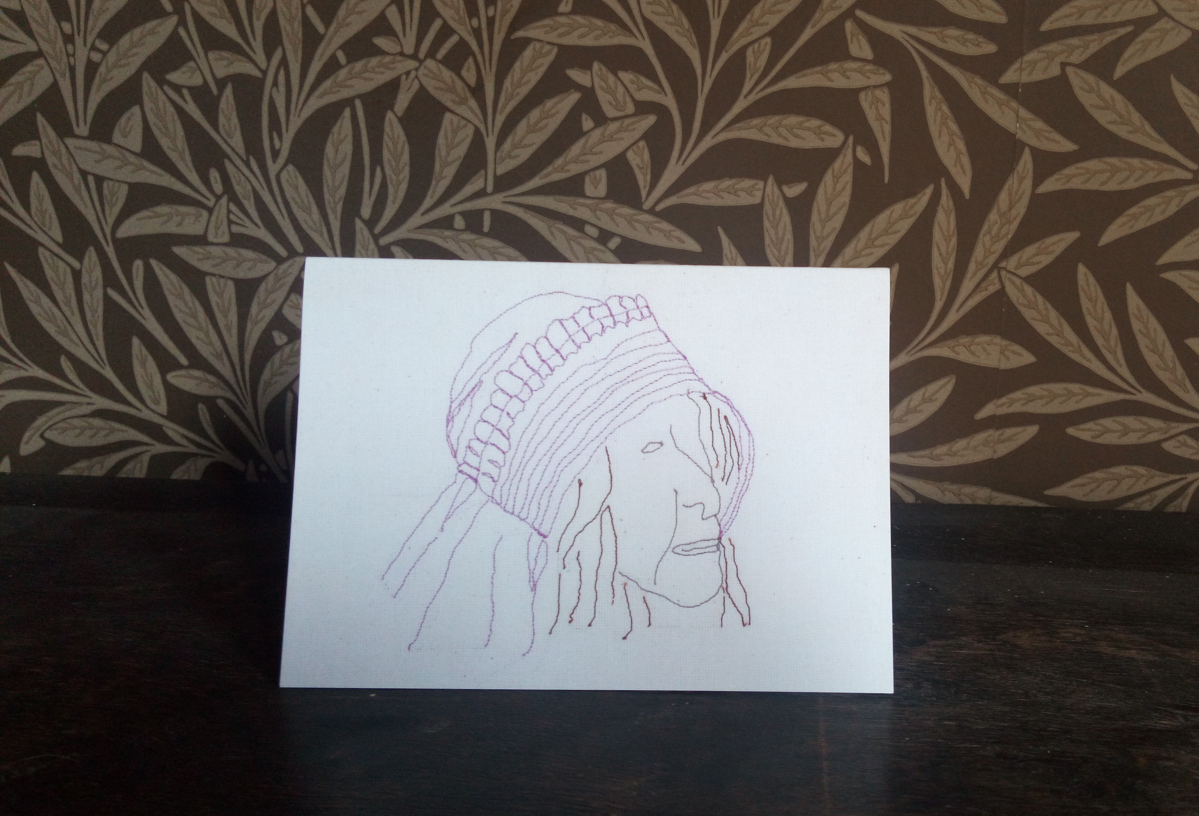 Greetings card featuring free motion embroidered textile artwork of a woman wearing a Staithes bonnet