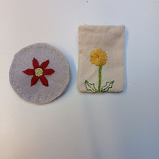 two hand embroidered brooches with flowers