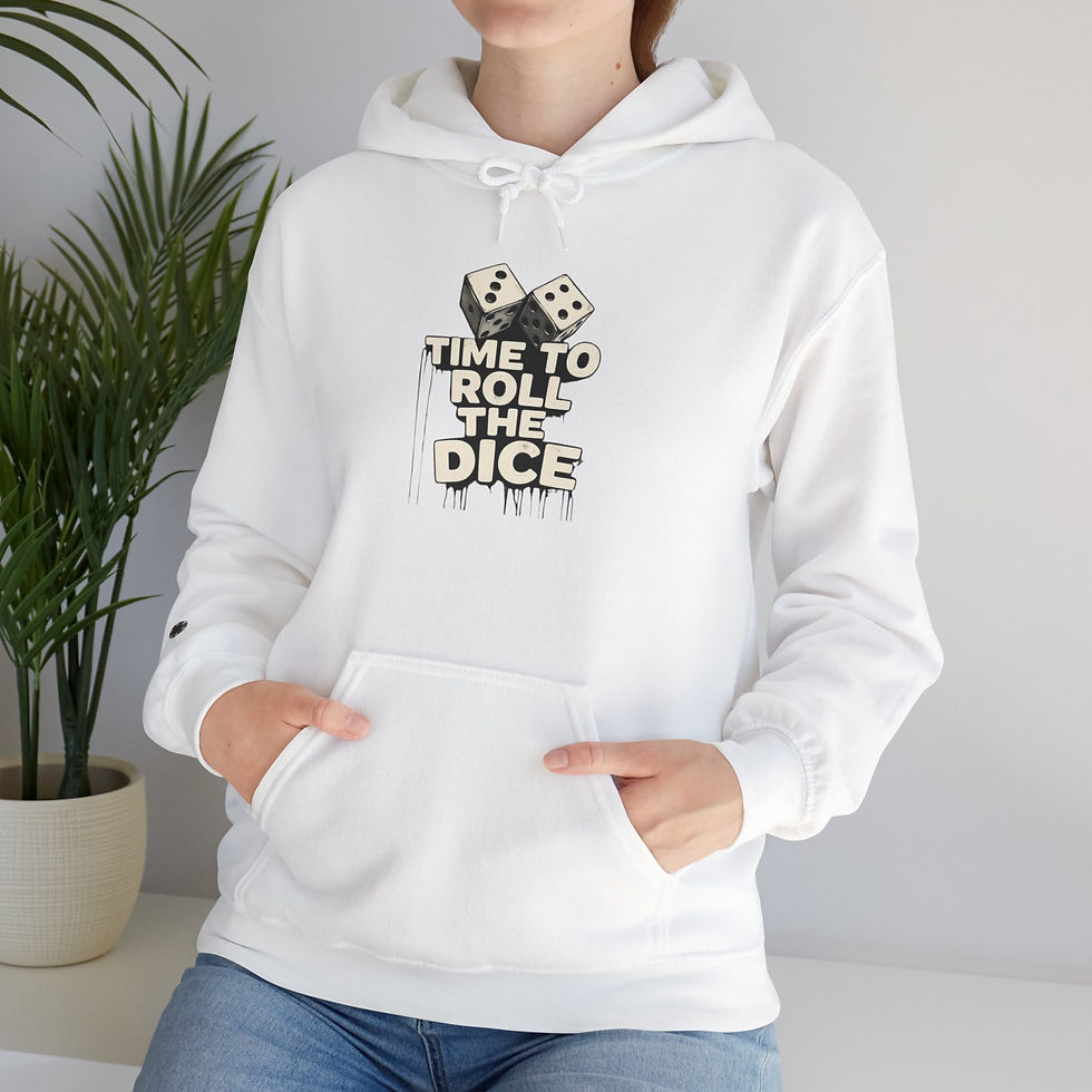 Person in white hoodie with dice graphic and TIME TO ROLL THE DICE text, standing indoors beside a potted plant.