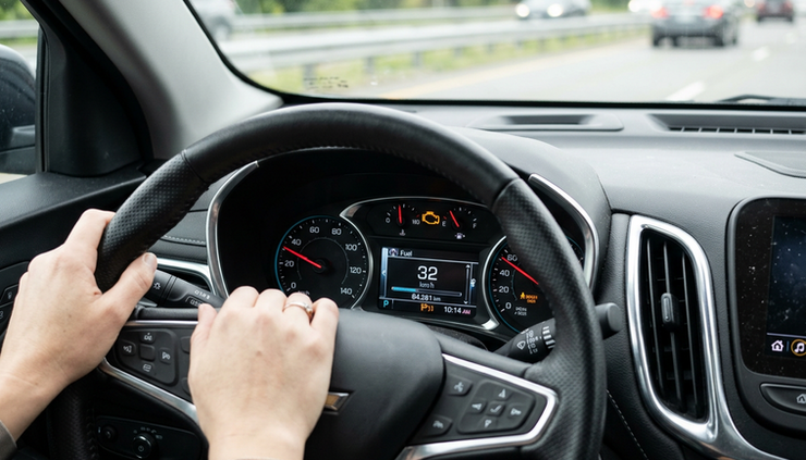Close-up view of an illuminated check engine light on a car dashboard