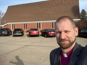 A man standing in front of a church.