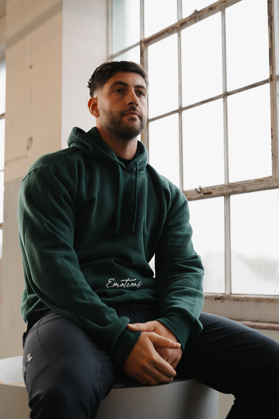 Bottle green everyday hoodie for men and women, front view showing relaxed unisex fit and ribbed cuffs