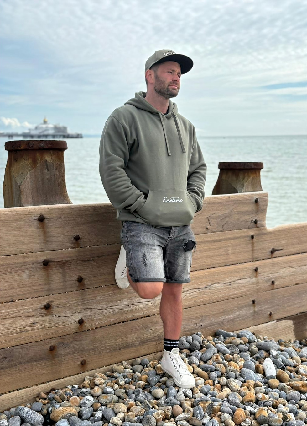 Styled photo of military green hoodie worn casually for modern streetwear