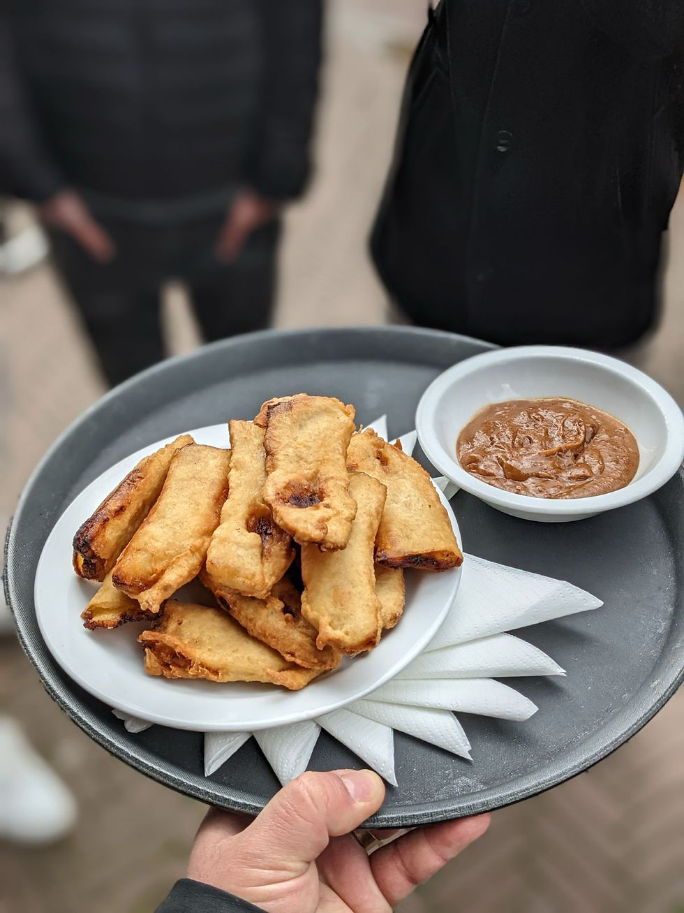 Surinamese baka bana, fried plantain in batter, served with peanut sauce in Amsterdam