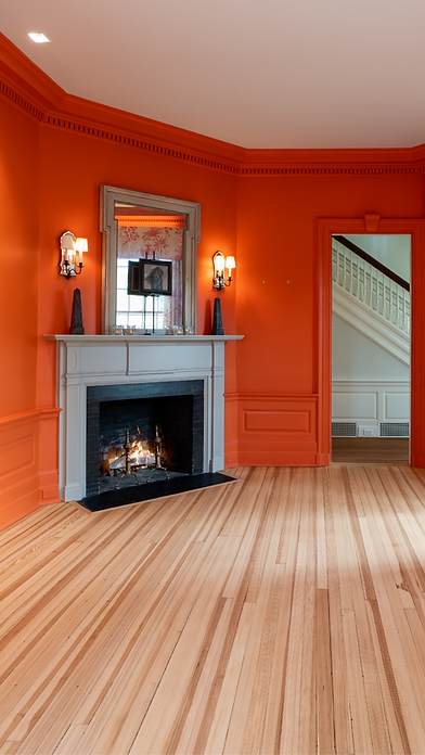 Coral dining room with fireplace, sconces and a view to the front stair, Litchfield CT