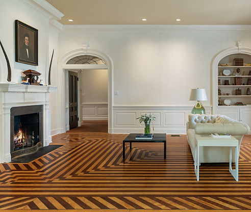 Living room with arched doorways, built-in shelves and a tufted sofa, Litchfield CT