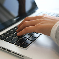 David Smith's fingers typing at a keyboard to research product information to create a compelling direct mail saies letter.
