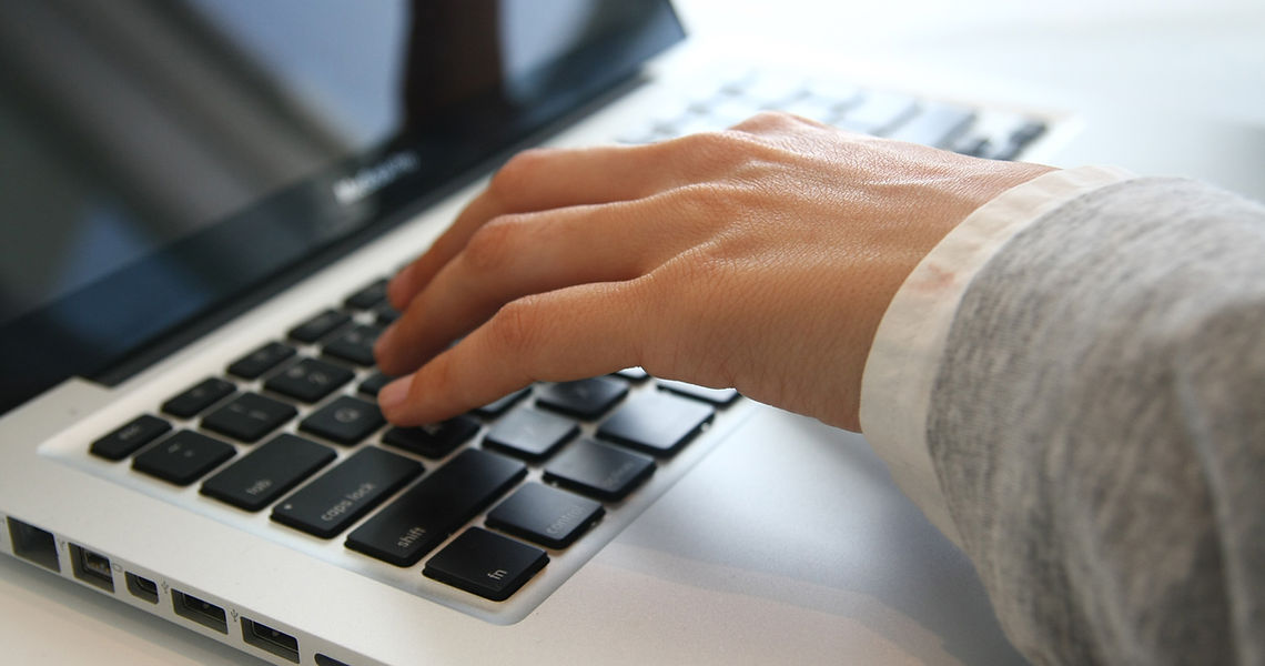 Hand on Laptop