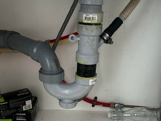 A leak under your kitchen sink is easy to blame on the P-trap, but that's not always where the problem starts. If water only appears when the sink is full or you notice drips near the top of the drain assembly, the basket strainer could be the real source of the leak.