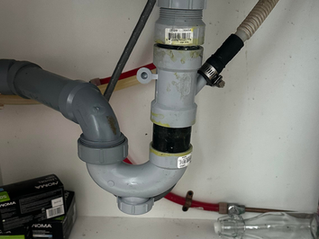 A leak under your kitchen sink is easy to blame on the P-trap, but that's not always where the problem starts. If water only appears when the sink is full or you notice drips near the top of the drain assembly, the basket strainer could be the real source of the leak.