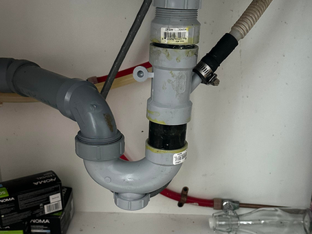 A leak under your kitchen sink is easy to blame on the P-trap, but that's not always where the problem starts. If water only appears when the sink is full or you notice drips near the top of the drain assembly, the basket strainer could be the real source of the leak.
