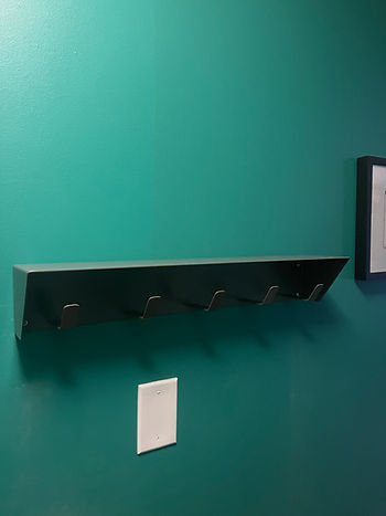 Professional wall mount installation of a shelf into a concrete wall at a downtown, Liberty Village, Toronto condo.