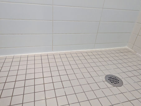 Cracked, mouldy deteriorating bathroom shower caulking removed and new shower silicone caulking professionally completed by HANDLD in Liberty Village, downtown Toronto