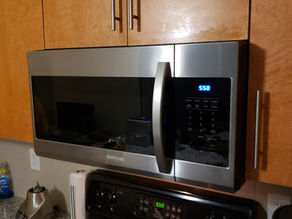 Professional installation of an over-the-range microwave in downtown Toronto
