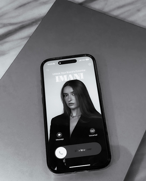Phone screen featuring a confident woman in black — modern and minimal brand consulting visual reflecting digital-era profess