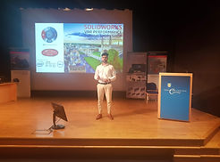 Picture of Sagar Agrawal standing on dice giving presentation