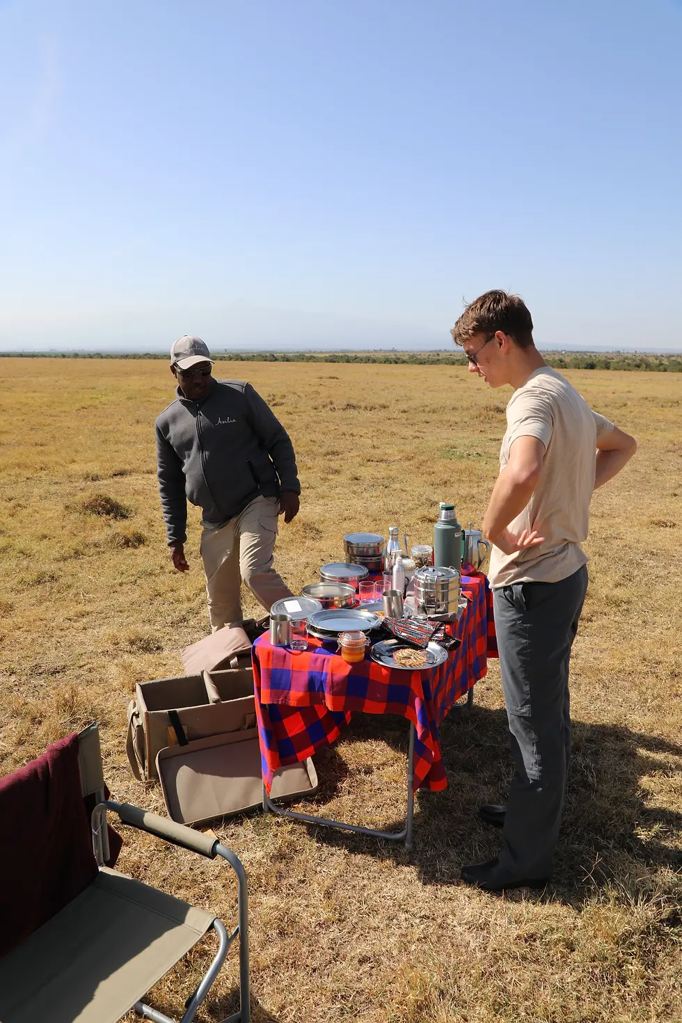 Our guide Abdi setting up breakfast under Dennis' supervision.
