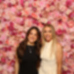 Two women posing in the photo booth