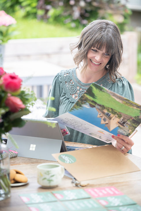 Estate Agent Becky from Sage Residential, looking at marketing brochures