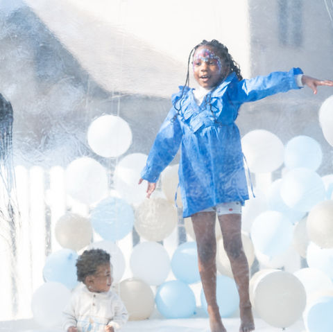 Little girl in bubble jumping castle