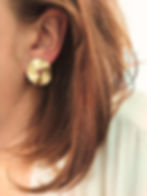Puces d'oreilles dorées en forme de soleil ondulées et dentelées.