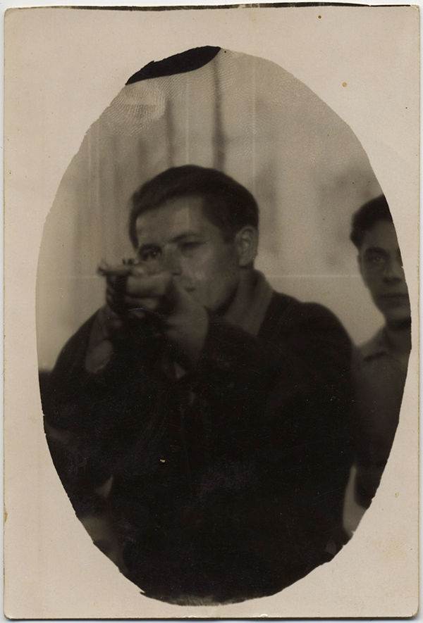 RPPC MAN in SHOOTING ARCADE FAIR GROUND AMUSEMENT AIMS RIFLE GUN at CAMERA