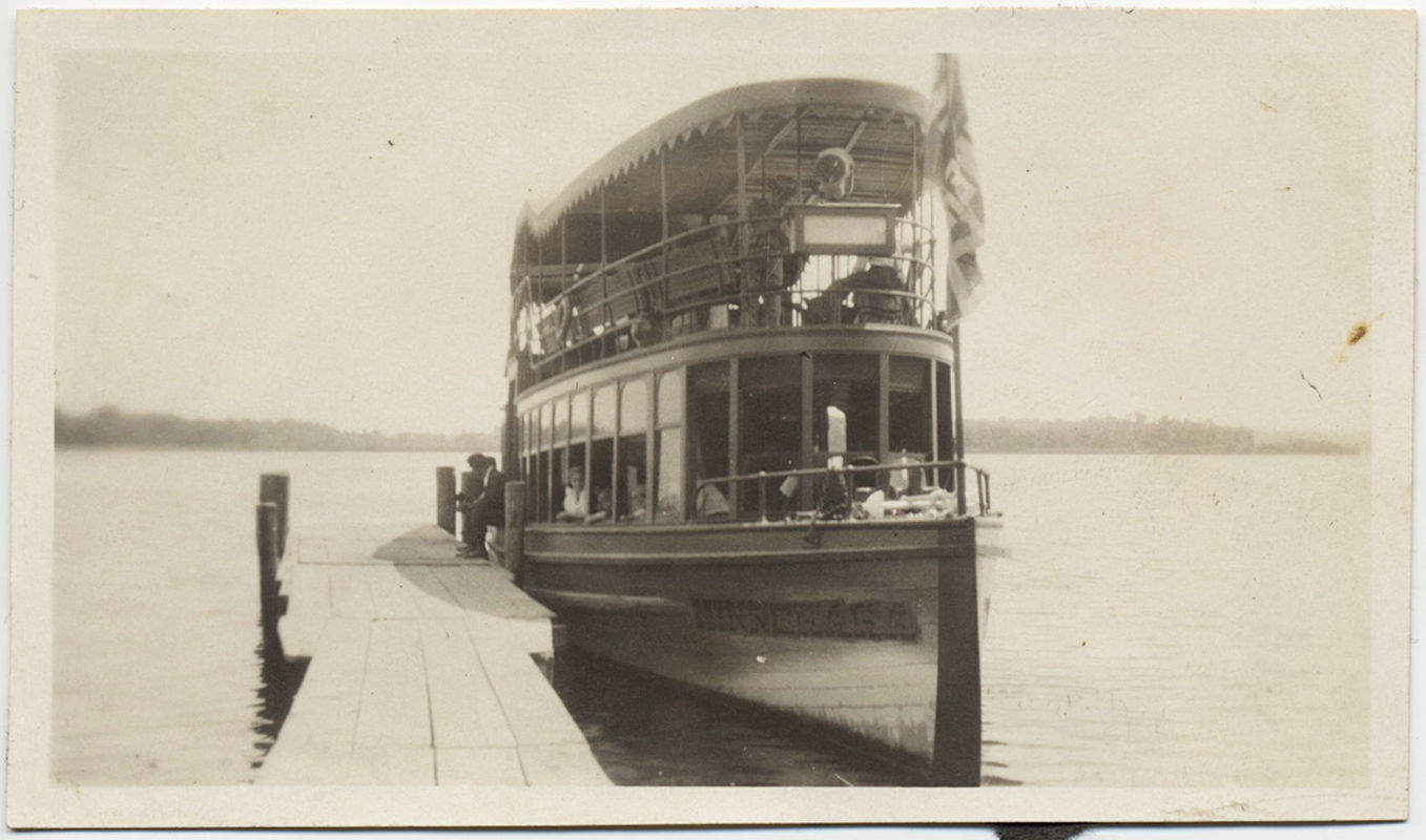 INTERESTING NARROW LAKE WOODEN TOUR EXCURSION BOAT DOCKED at JETTY