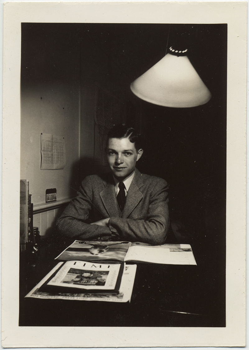 STUDIOUS HANDSOME YOUNG MAN READS MAGAZINES including TIME MAGAZINE