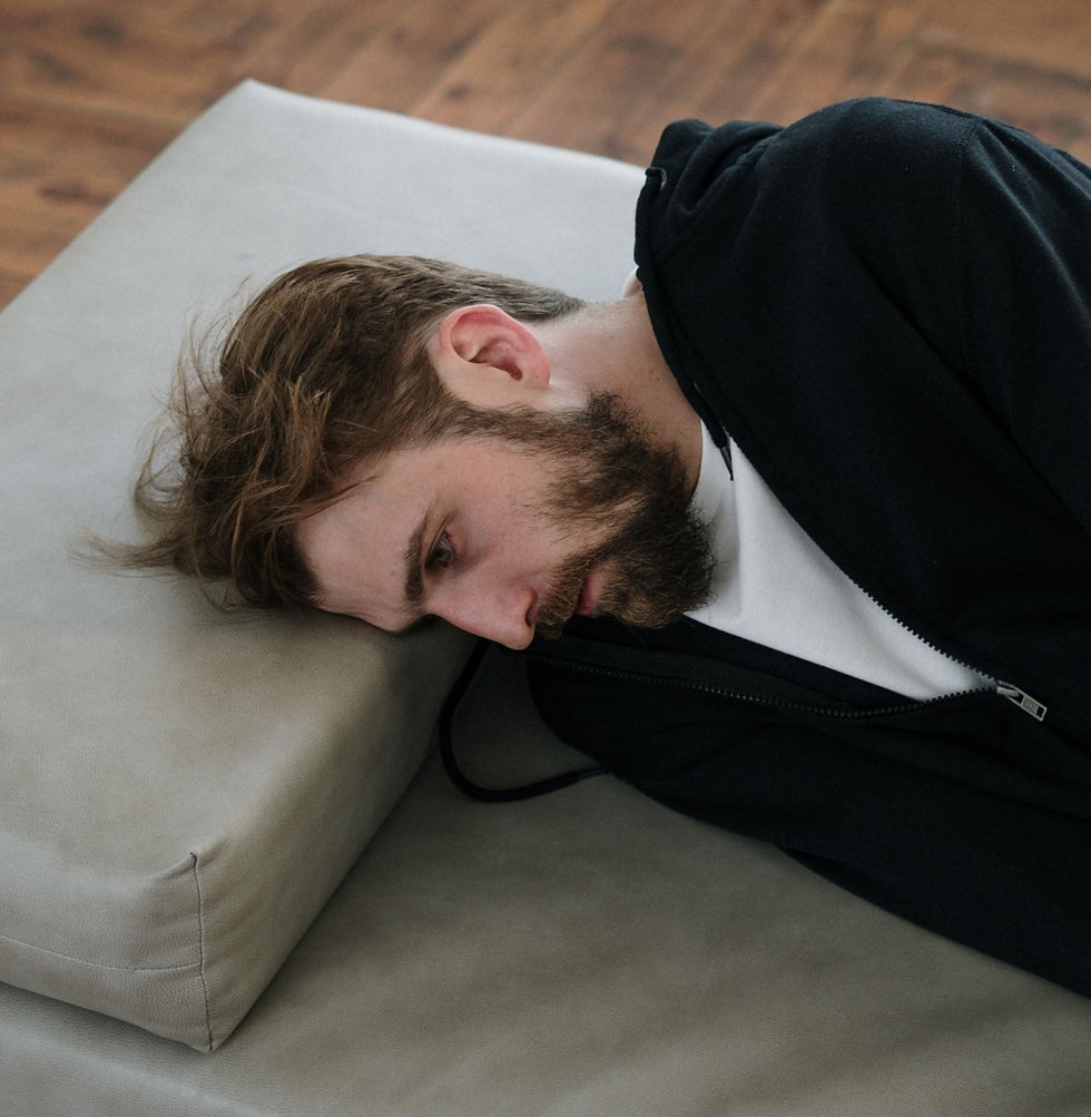 man lying in bed trying to understand his own emotions due to autism and alexithymia