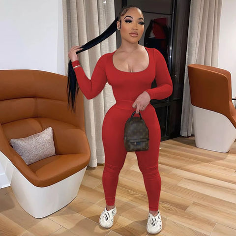 Woman in red ribbed long-sleeve fitted jumpsuit