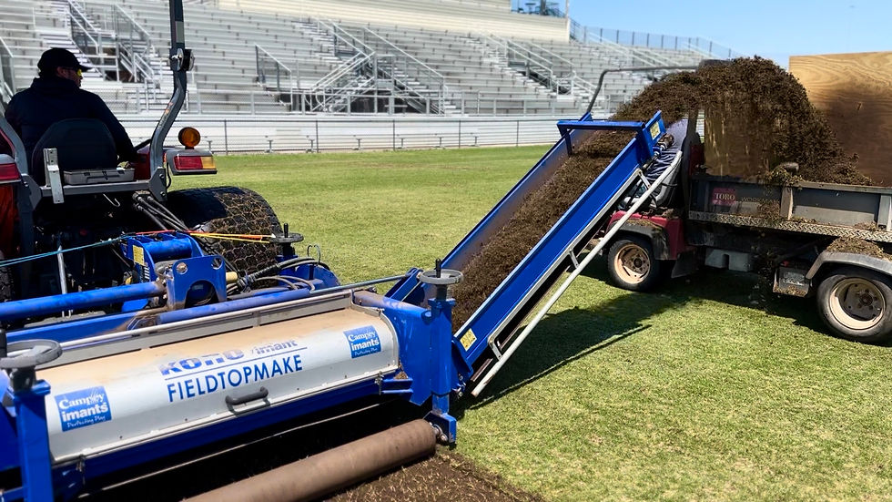 SFS crew operating a Koro FieldTopMaker during a fraise mowing service at UTSA's Crossroads Park Athletic Complex, spring 2024 — removing the native soil sod layer and poa annua seedbed from the soccer pitch ahead of summer bermudagrass transition.