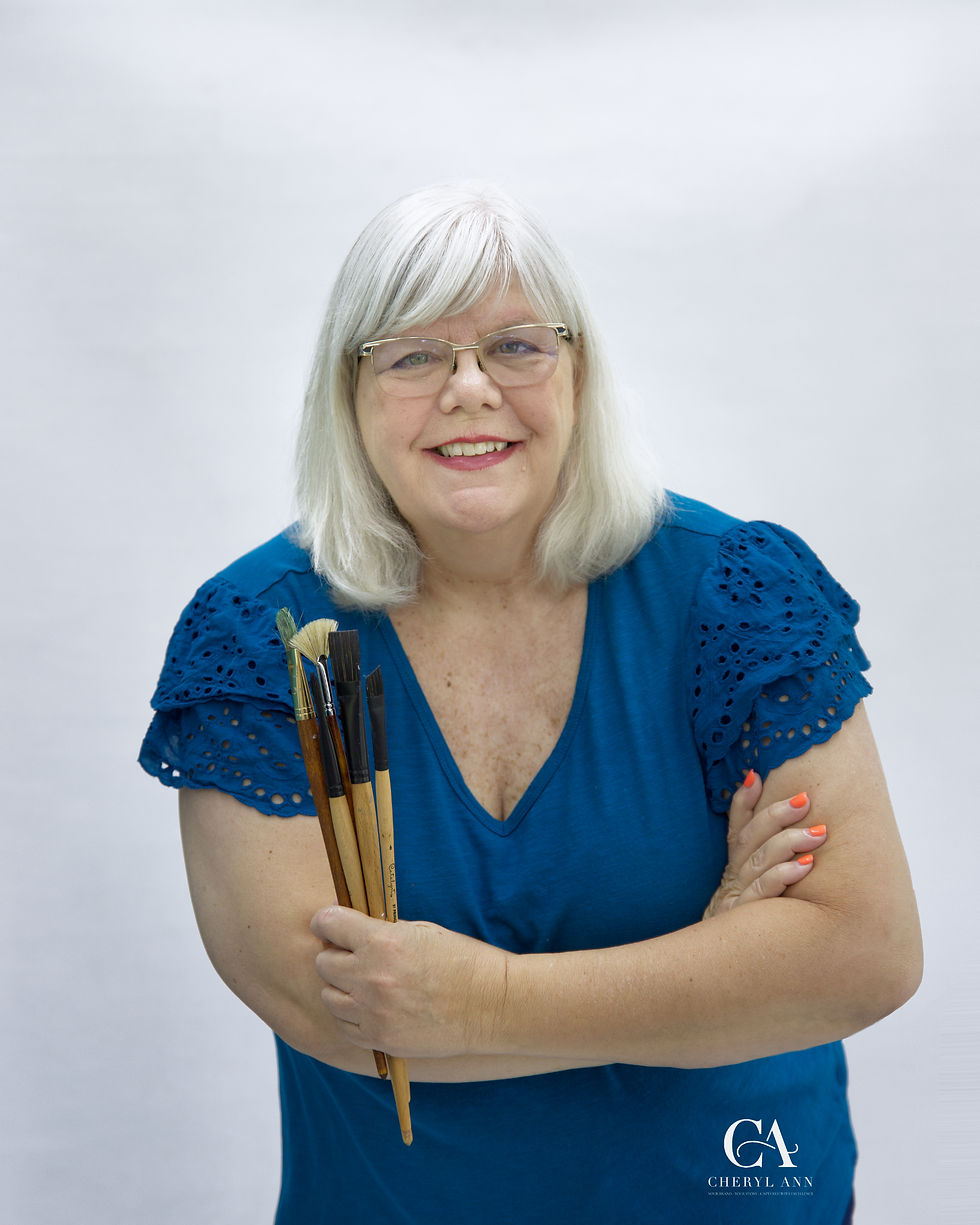 Personal Branding Photography of Local Artist holding paint brushes and smiling