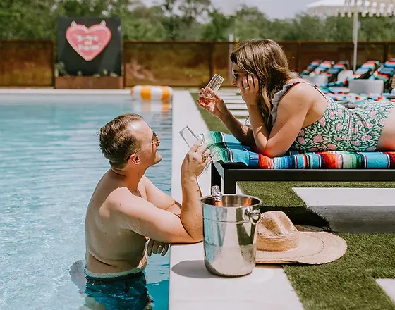 Couple at the resort style pool at adult only retreat Melrose River Club.webp