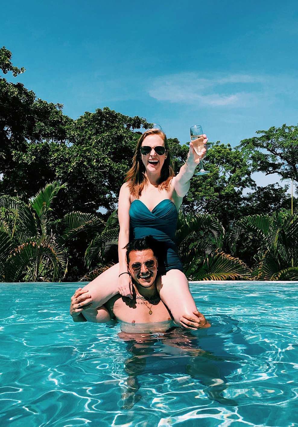 Couple with champagne at luxury Belize Eco-lodge Copal Tree Lodge.webp