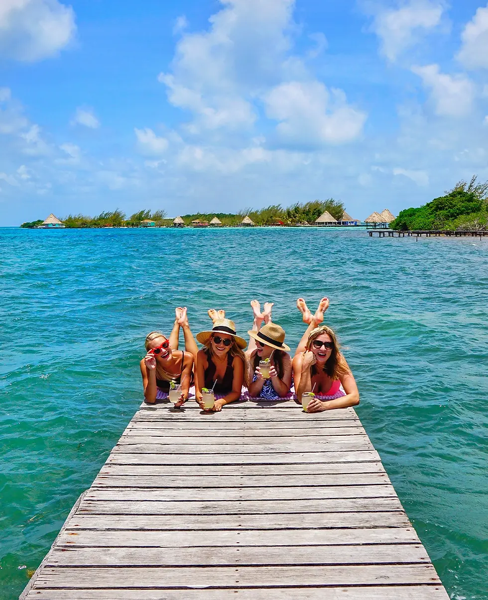 Girl's trip vacation in Overwater bungalow Private Island Thatch Caye Belize.webp