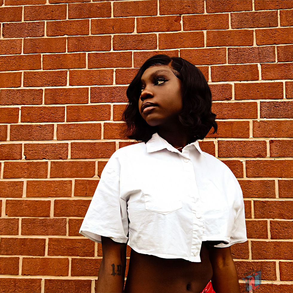 Woman in white top against brick wall
