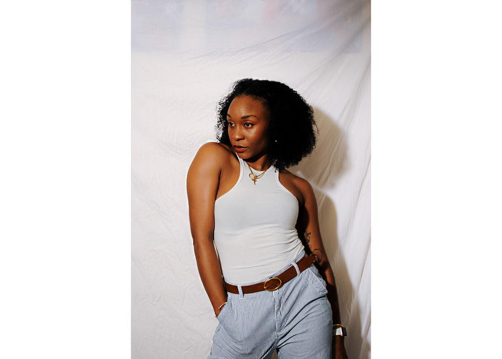 Stylish woman in white top and striped pants