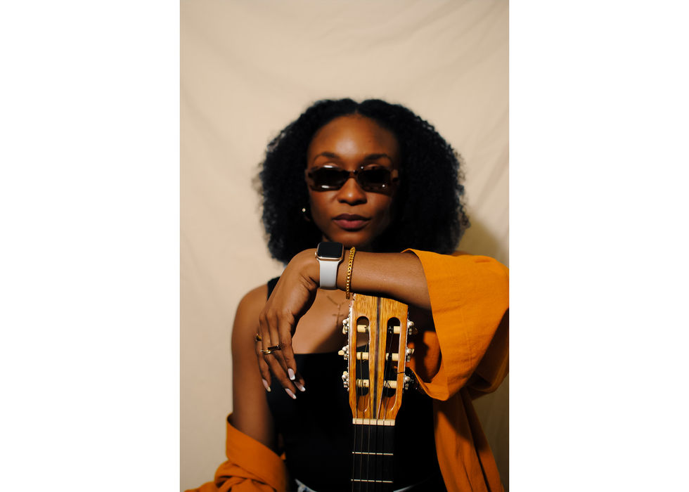 Woman with sunglasses and acoustic guitar