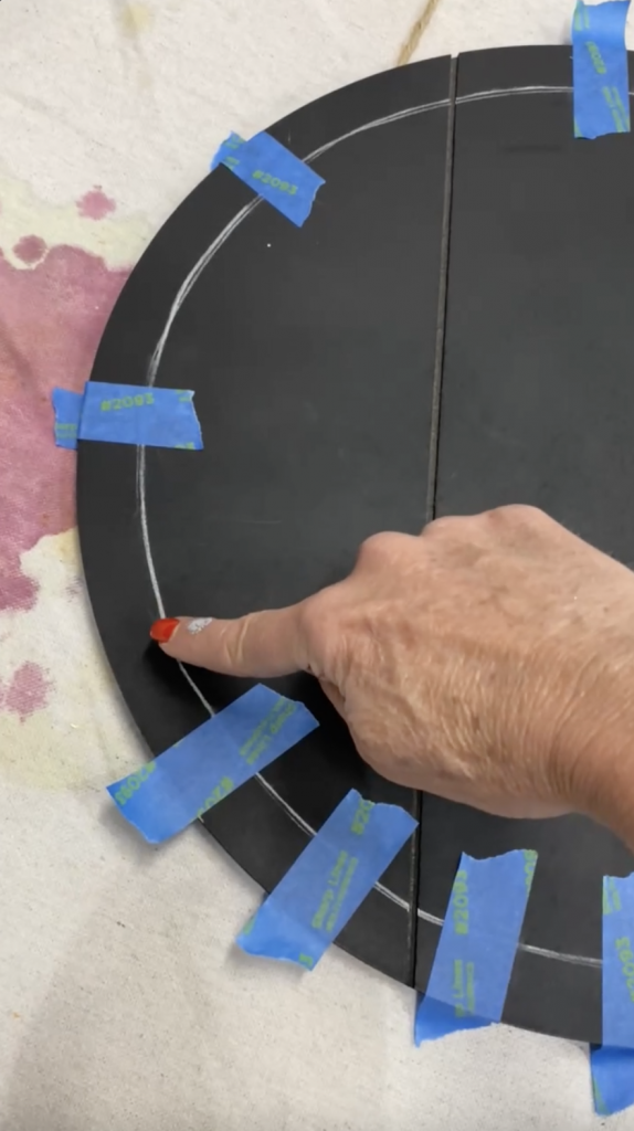 Tracey's Fancy creating a pattern with painter's tape on a DIY door hanger.