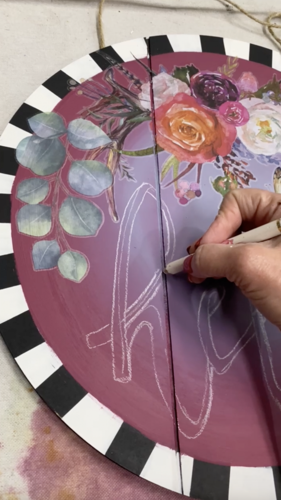 Tracey's Fancy drawing the word Hello with chalk on her DIY door hanger.